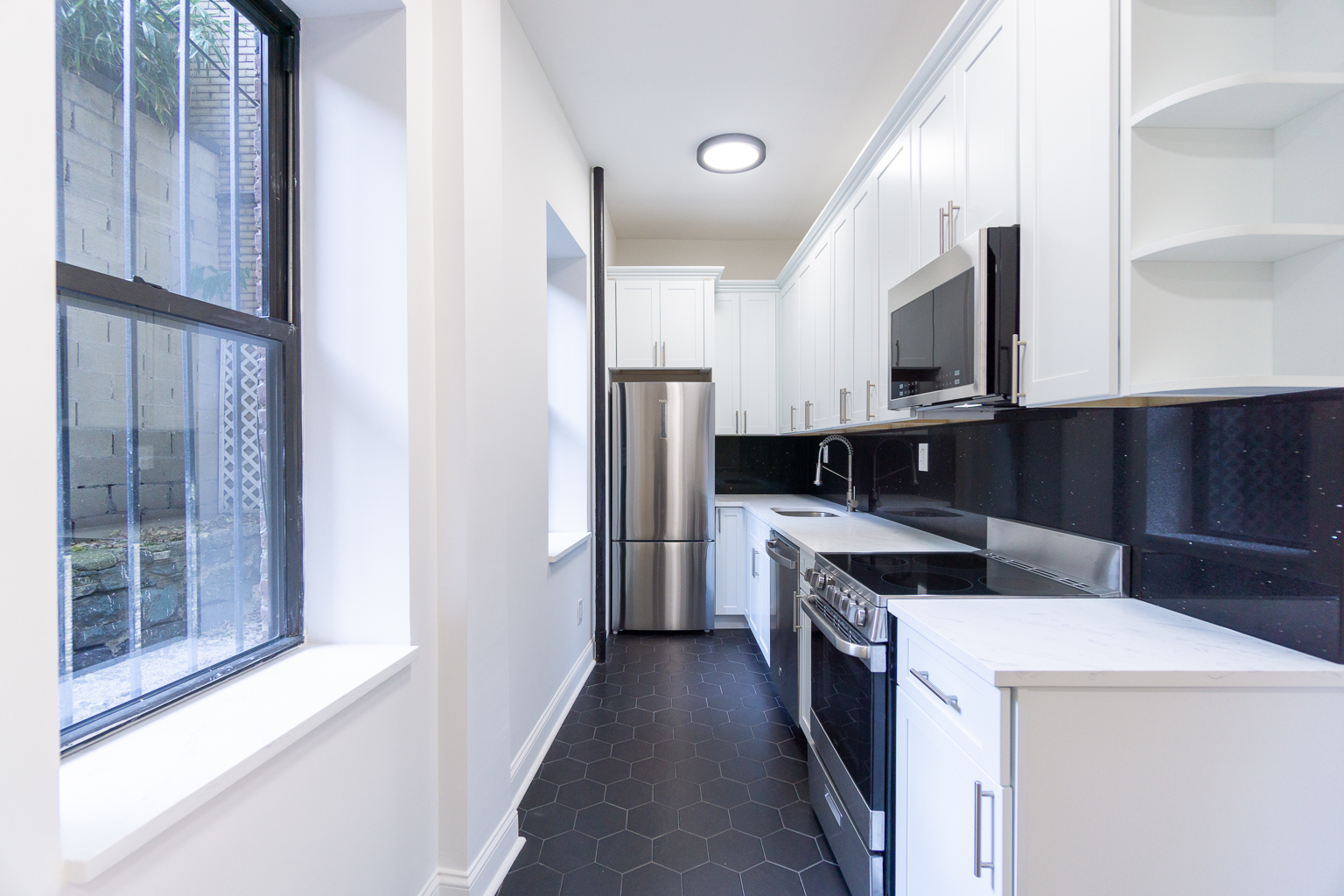 51 East 2nd Street, Unit 2 Manhattan, NY 10003 - Photo 6 of 18 a kitchen with a refrigerator stove and microwave