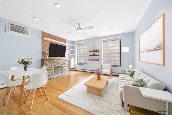 a living room with fireplace furniture and a flat screen tv