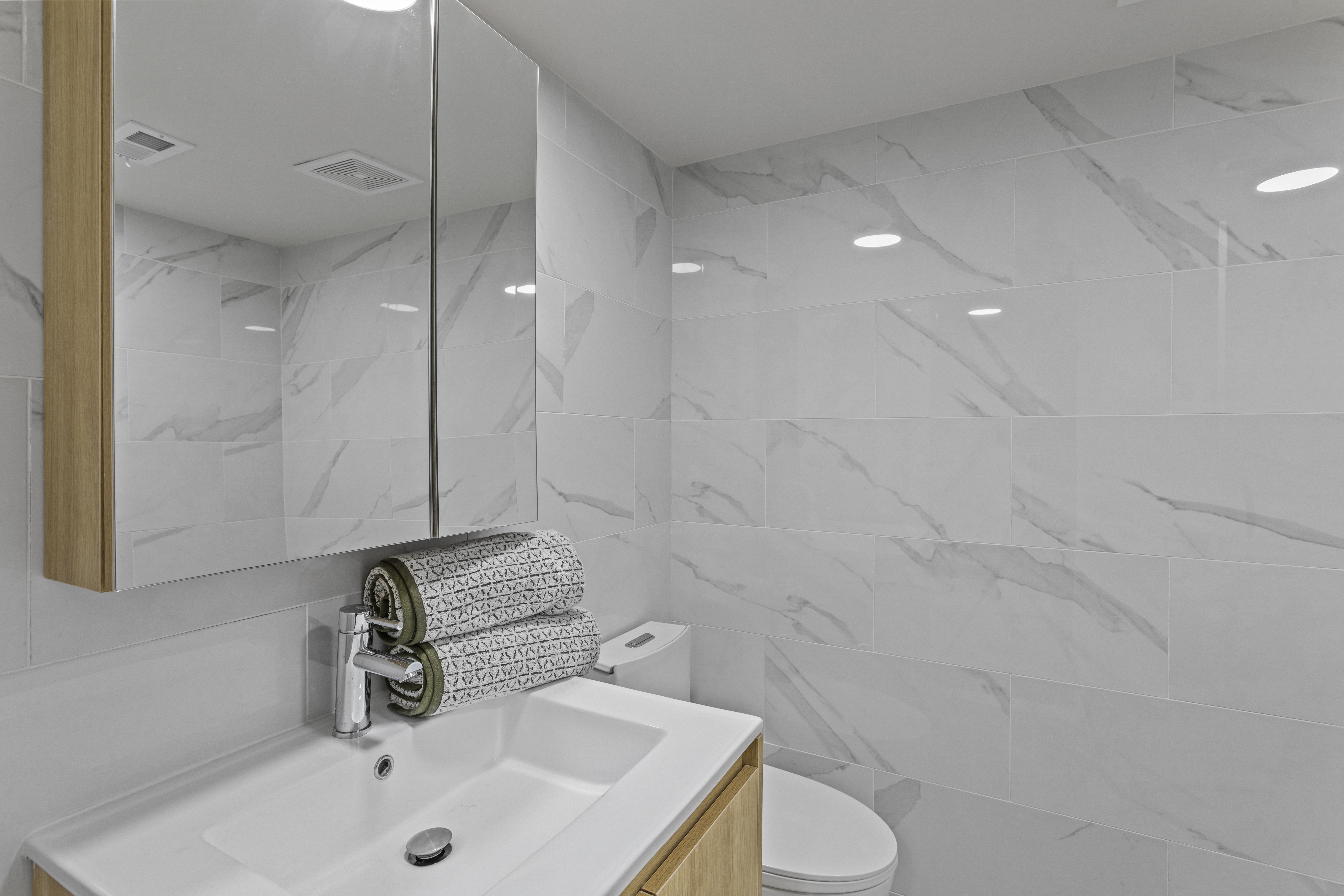 3112 Emmons Avenue, Unit 3140A-2 Brooklyn, NY 11235 - Photo 8 of 13 a bathroom with a sink and a mirror