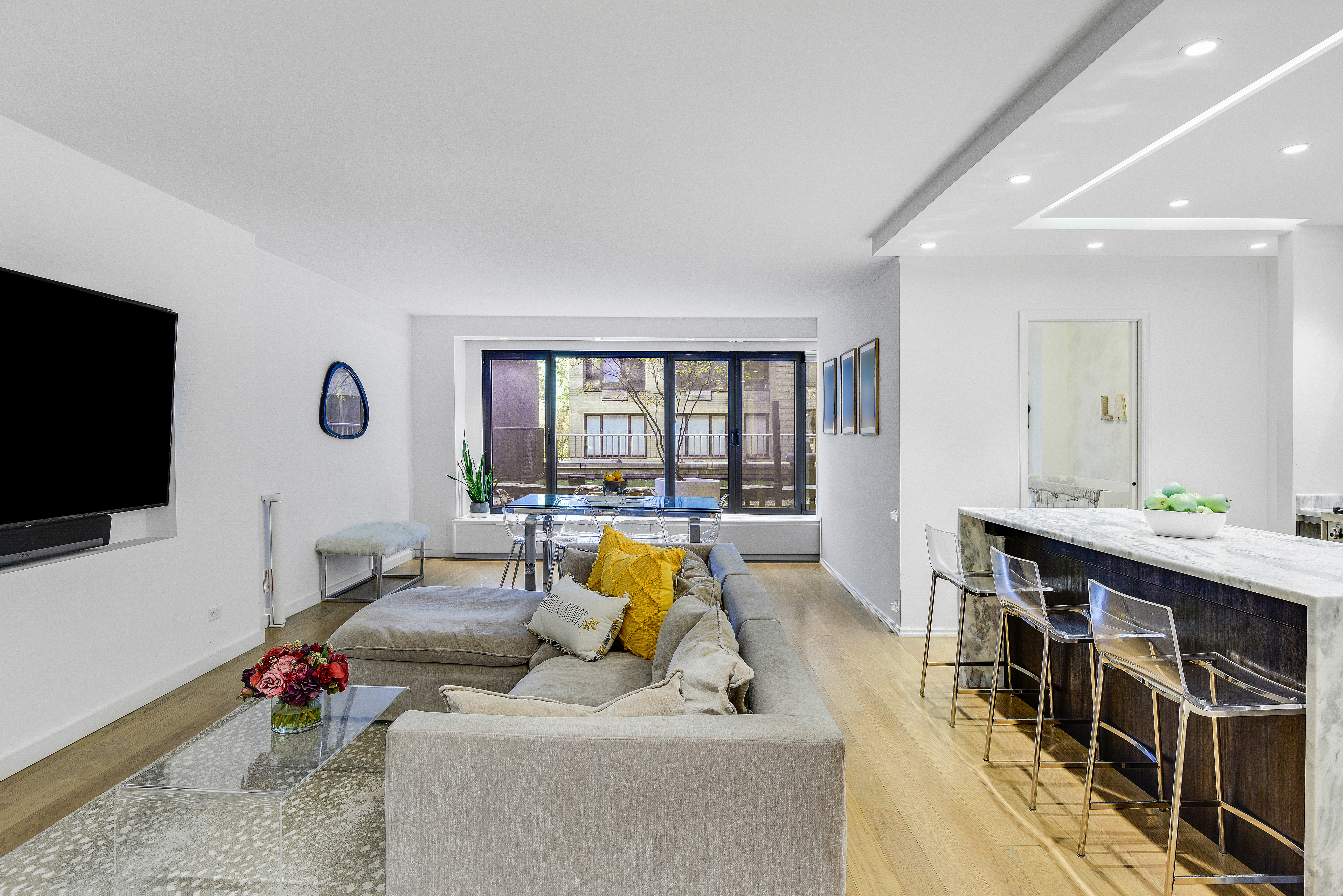200 Central Park South, Unit 3Q Manhattan, NY 10019 - Photo 2 of 15 a living room with furniture and a flat screen tv