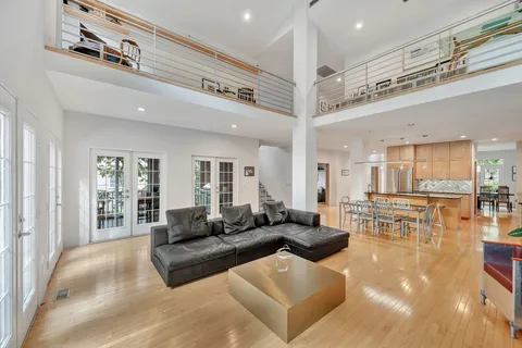 a living room with furniture a window and a potted plant