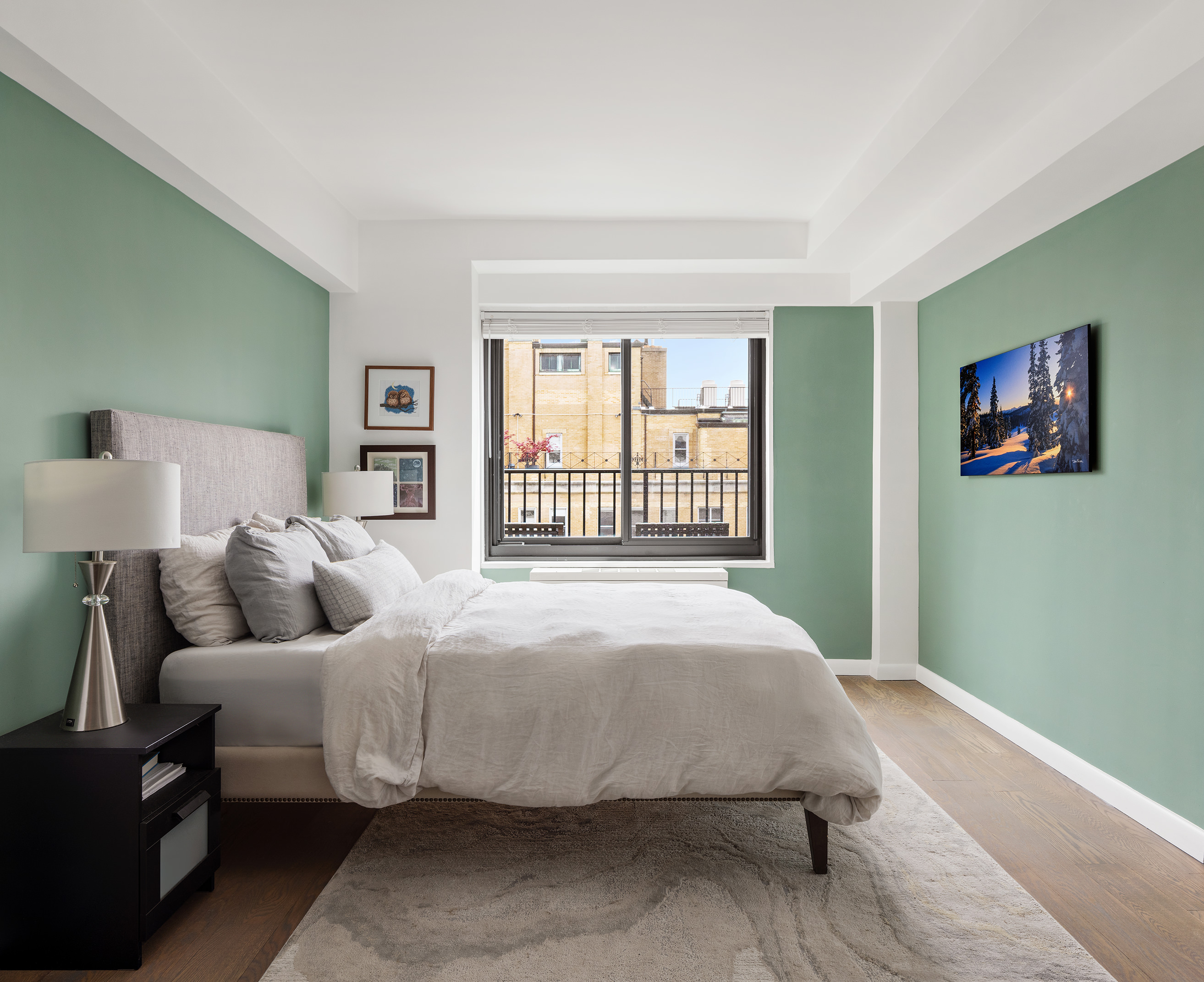 10 East End Avenue, Unit 18D Manhattan, NY 10075 - Photo 15 of 21 a bedroom with a bed and wooden floor