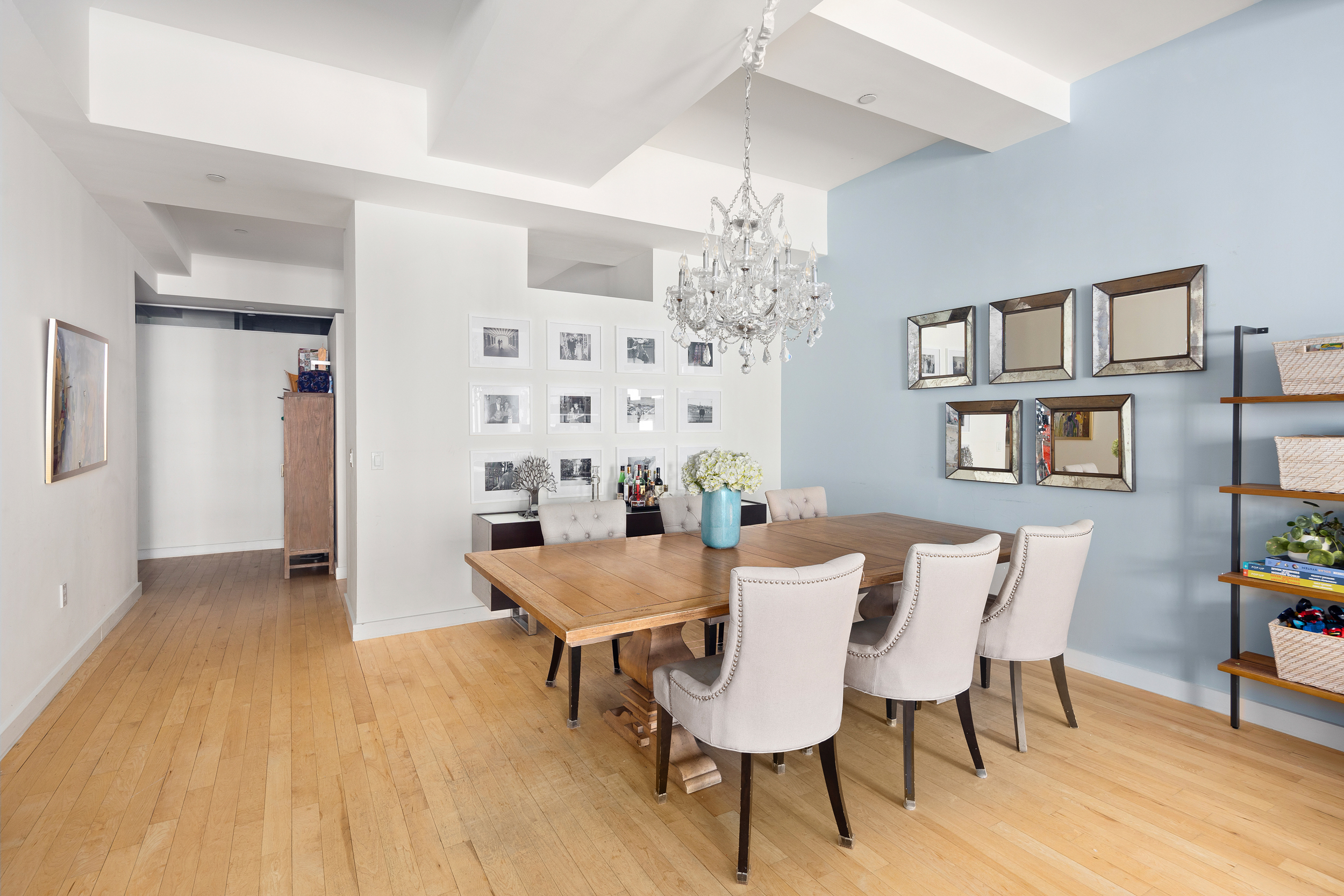 15 Broad Street, Unit 2404 Manhattan, NY 10005 - Photo 3 of 23 a view of a dining room with furniture and chandelier