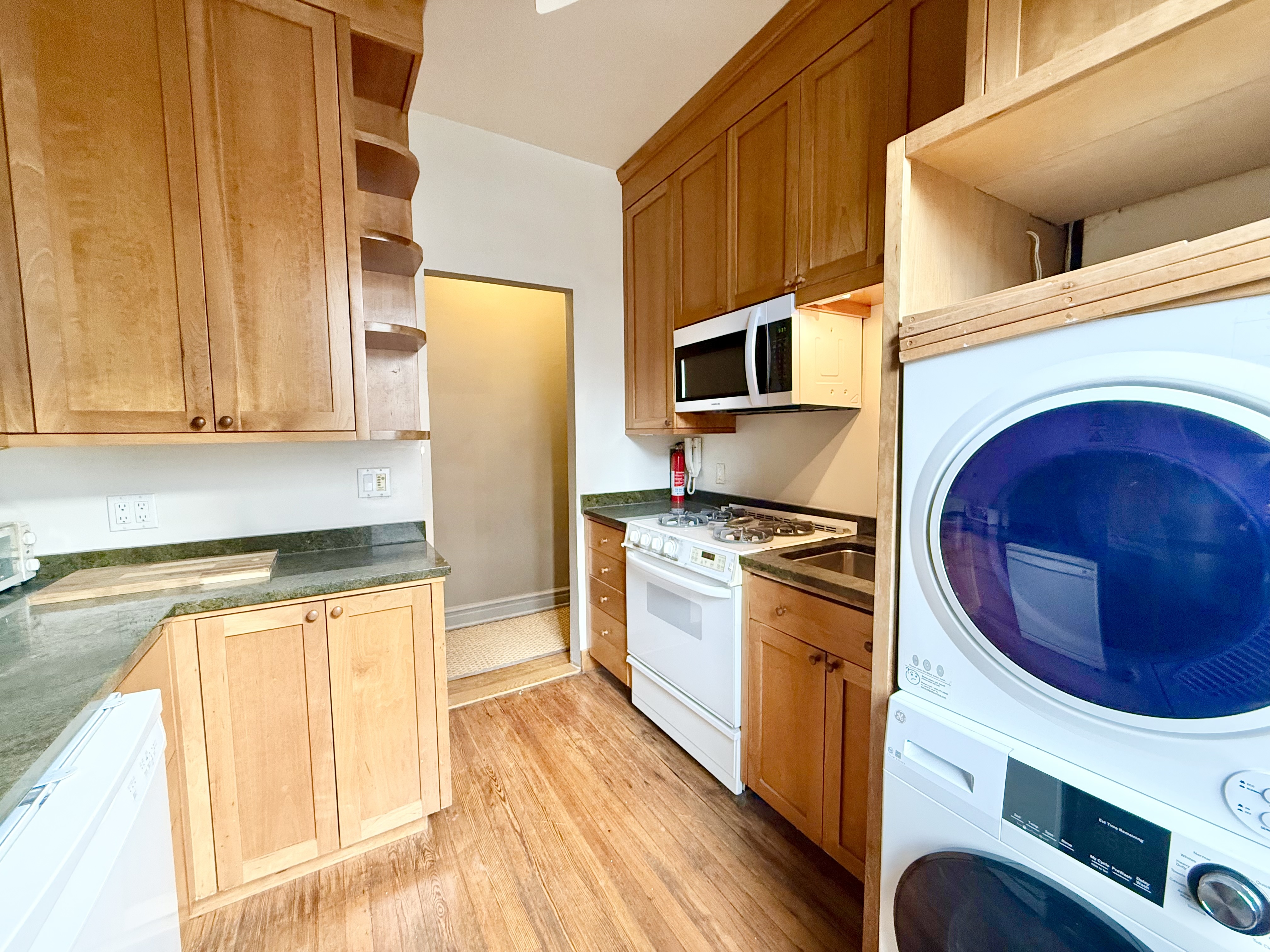 170 Claremont Avenue, Unit 19 Manhattan, NY 10027 - Photo 7 of 9 a kitchen with stainless steel appliances granite countertop a stove a sink and a refrigerator