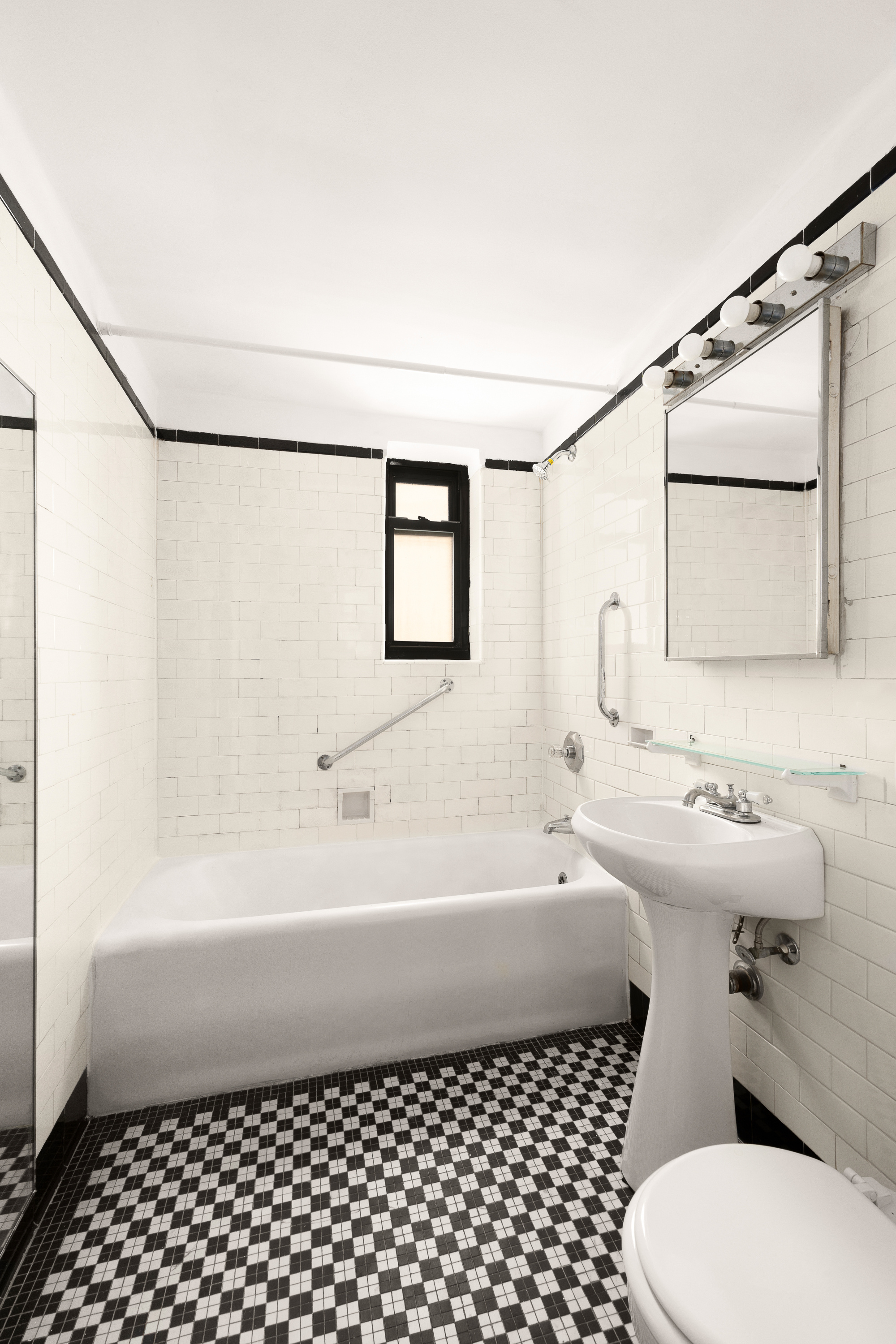 465 West 23rd Street, Unit 10A Manhattan, NY 10011 - Photo 8 of 12 a bathroom with a sink a toilet and a shower