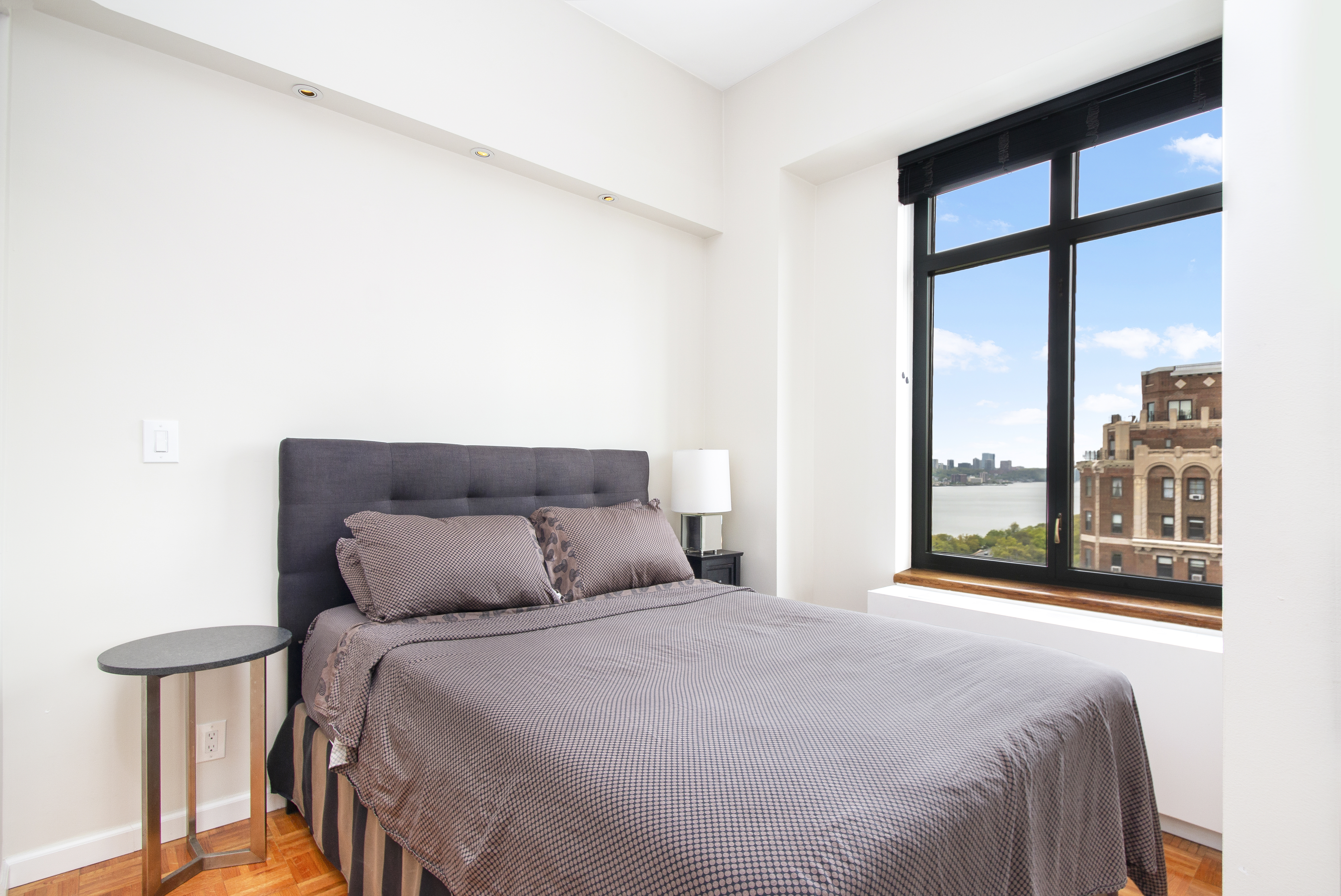 222 Riverside Drive, Unit PH2E Manhattan, NY 10025 - Photo 4 of 18 a bedroom with a large bed and a large window