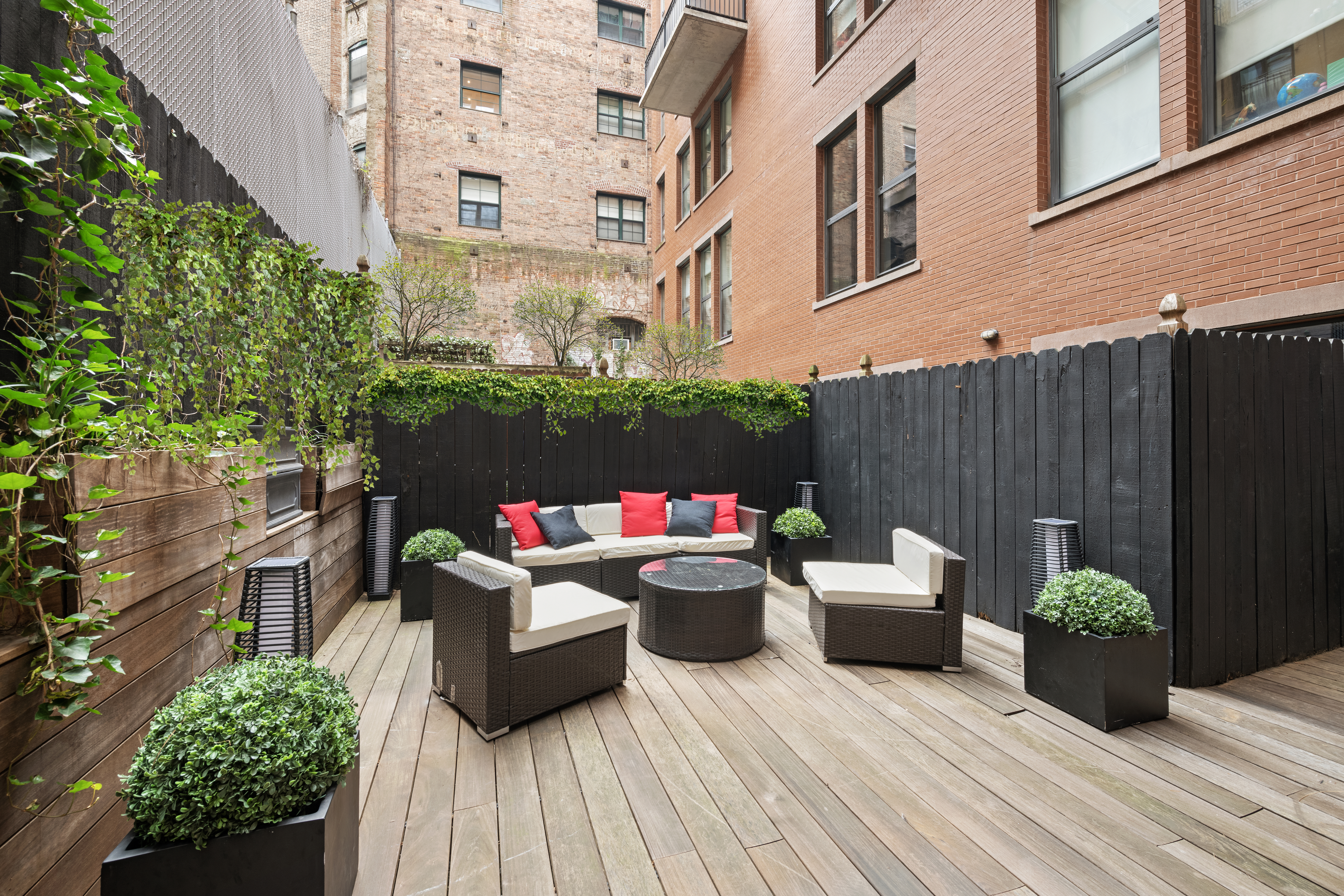 415 Washington Street, Unit 1B Manhattan, NY 10013 - Photo 15 of 16 a view of a patio with couches and potted plants