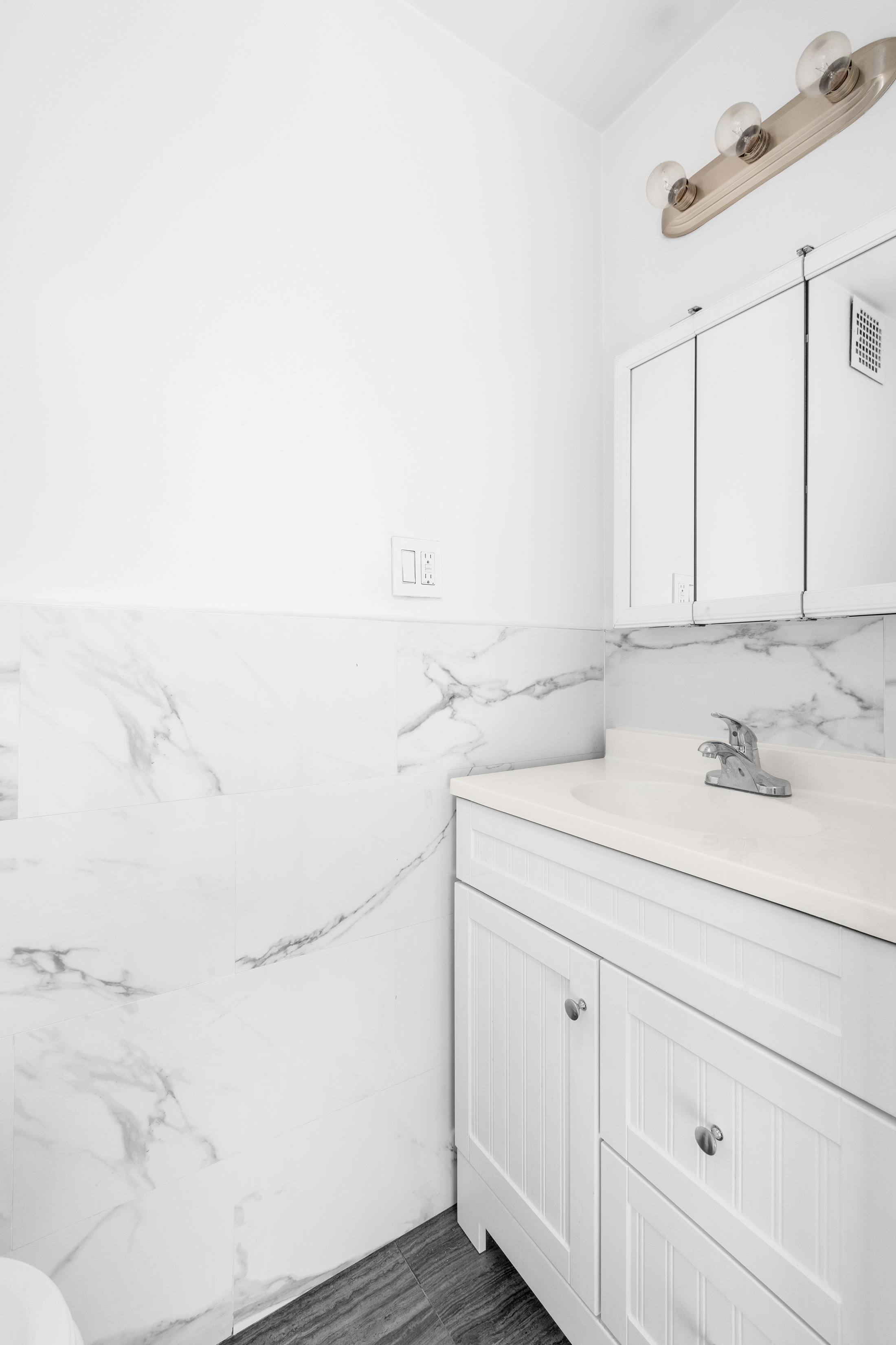 1582 York Avenue, Unit 5B Manhattan, NY 10028 - Photo 7 of 14 a bathroom with a sink and a mirror