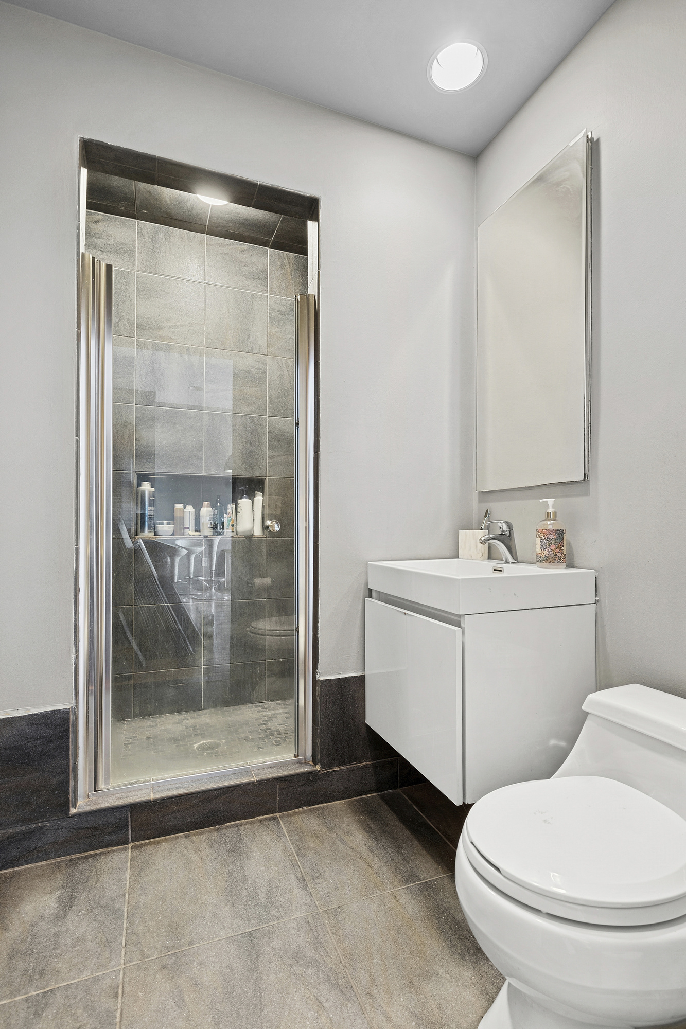 14-25 Broadway, Unit 5R Queens, NY 11106 - Photo 5 of 5 a bathroom with a sink a toilet and shower