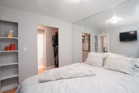 a bedroom with a bed and a flat screen tv