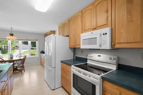 a kitchen with a white stove top oven and refrigerator