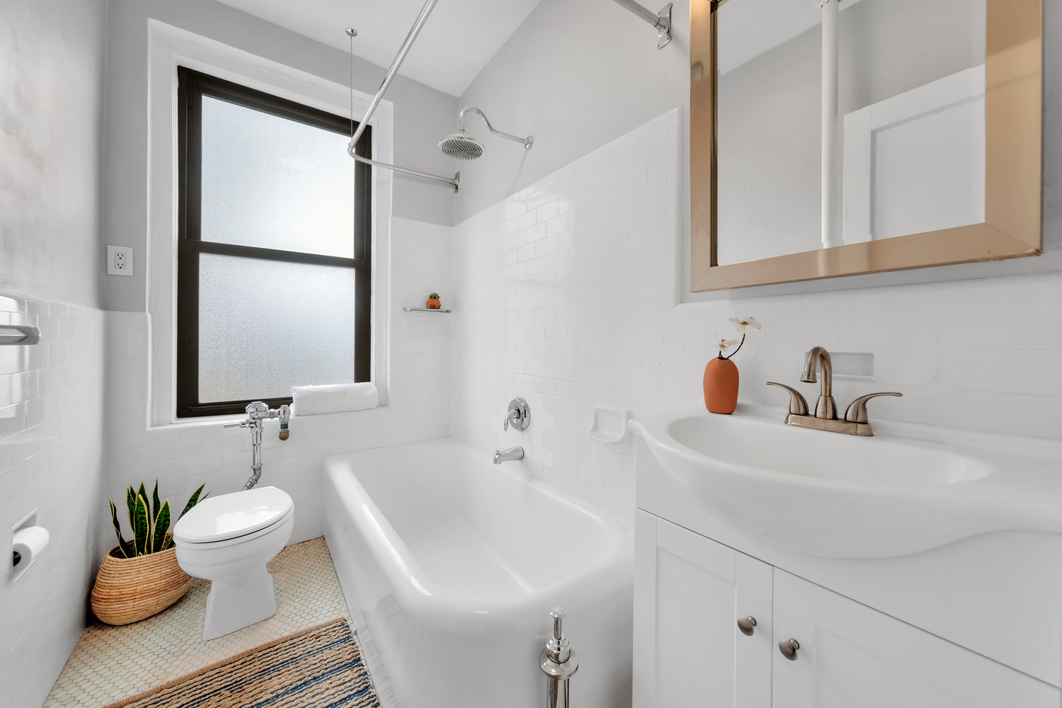 172 East 4th Street, Unit 8F Manhattan, NY 10009 - Photo 9 of 11 a bathroom with a sink toilet and a mirror