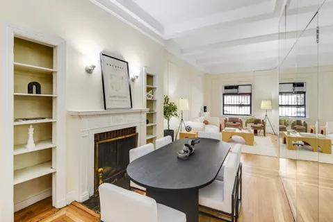 a living room with furniture kitchen view and a fireplace