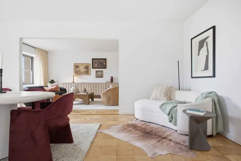a living room with furniture and a mirror