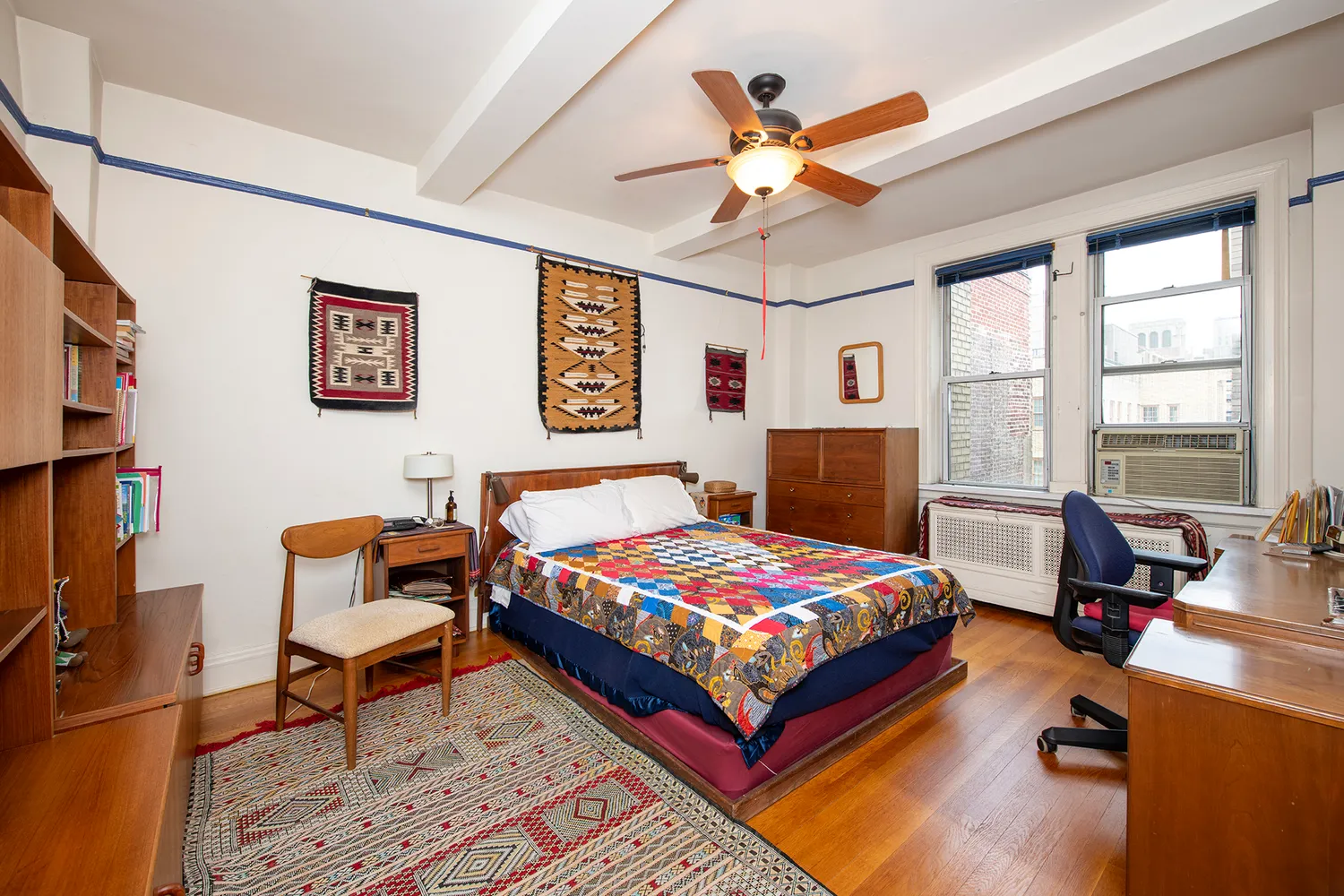 a bedroom with a bed work place and a window