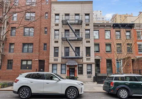 a front view of a residential apartment building with a parking space
