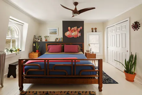 a bedroom with a bed table and window