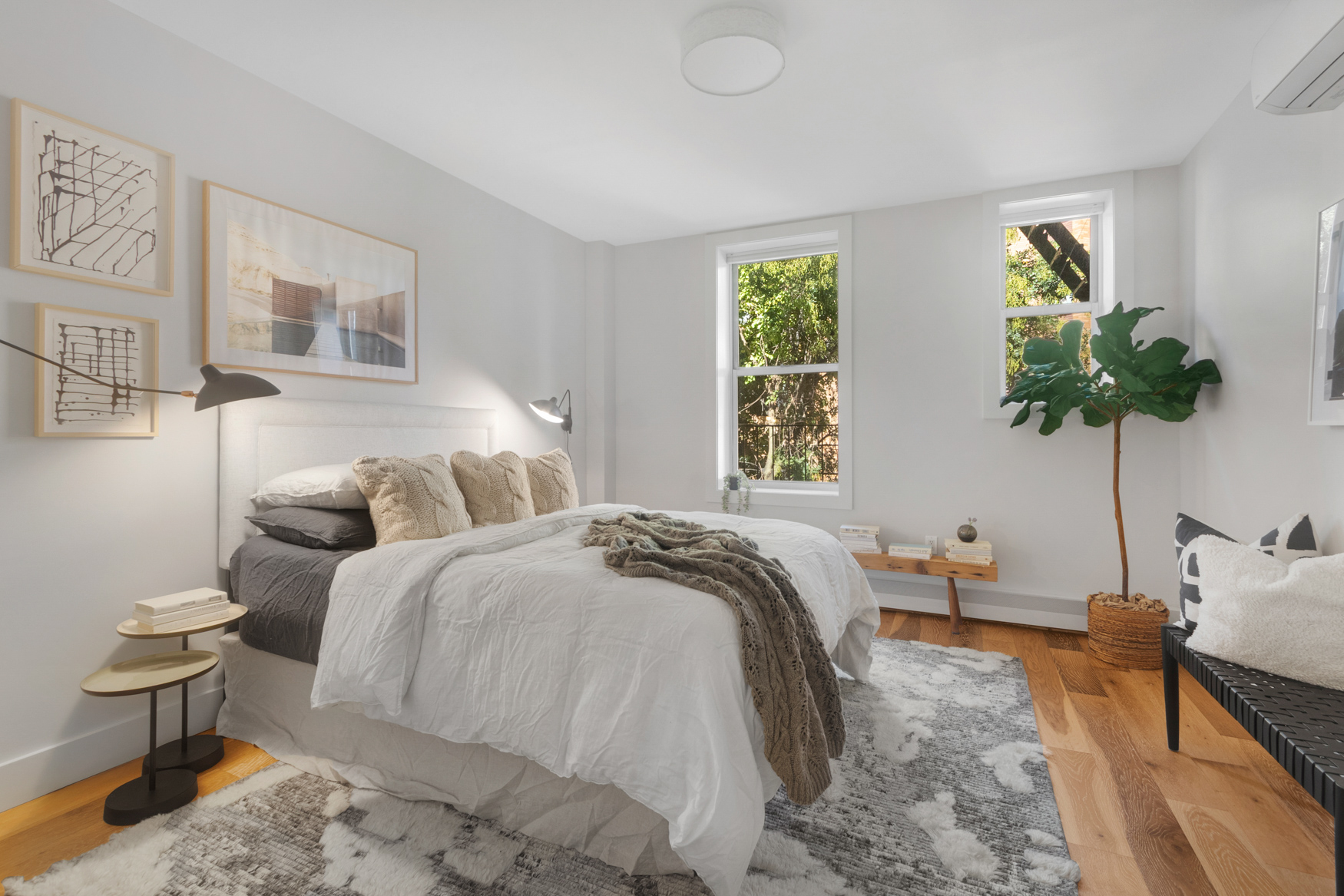 249 Hull Street, Unit 249C Brooklyn, NY 11233 - Photo 8 of 14 a bedroom with a bed a potted plant and a window