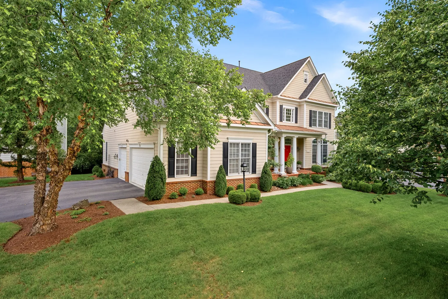 a view of a house with a yard and sitting area