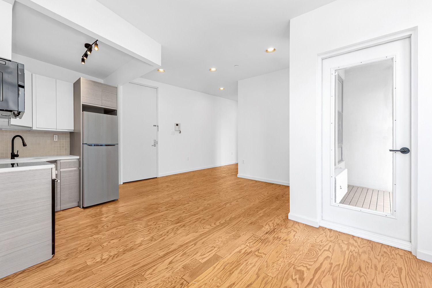 452 Lafayette Avenue, Unit 4B Brooklyn, NY 11205 - Photo 5 of 15 a view of a kitchen with a sink and a refrigerator
