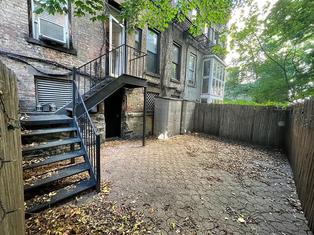 317 East 73rd Street, Unit 1RE Manhattan, NY 10021 - Photo 2 of 9 a backyard of a house with lots of green space