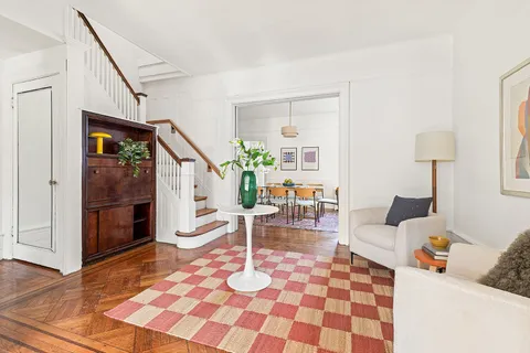a living room with furniture and a rug