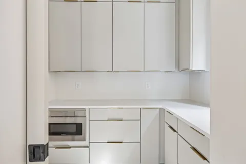 a bathroom with a granite countertop toilet a sink and a bathtub