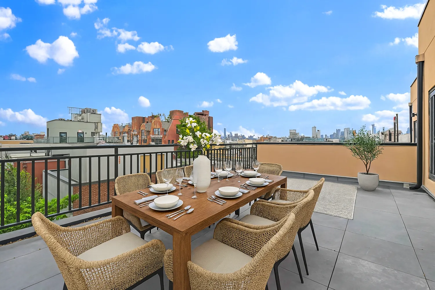 a view of a terrace with furniture and city view