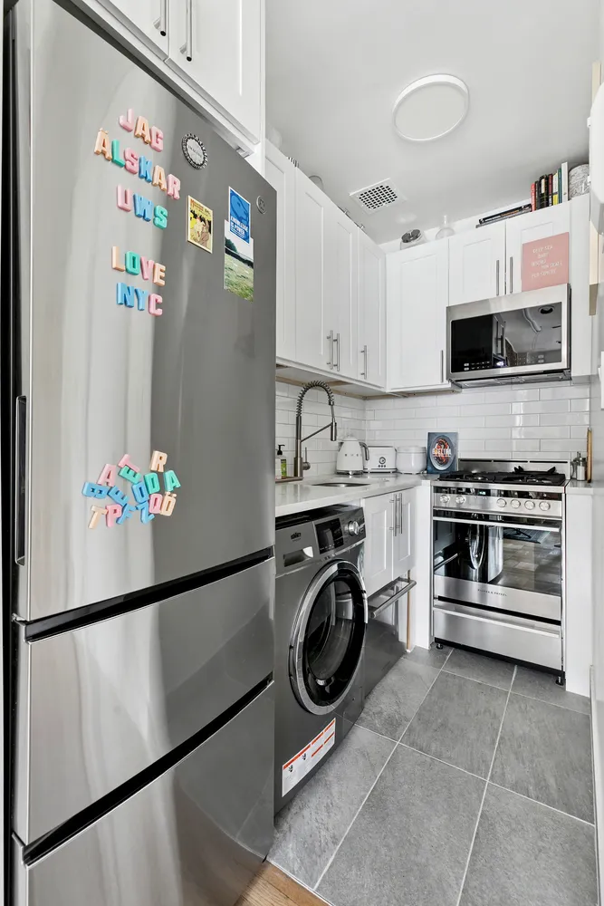 a kitchen with stainless steel appliances granite countertop a refrigerator and a stove top oven