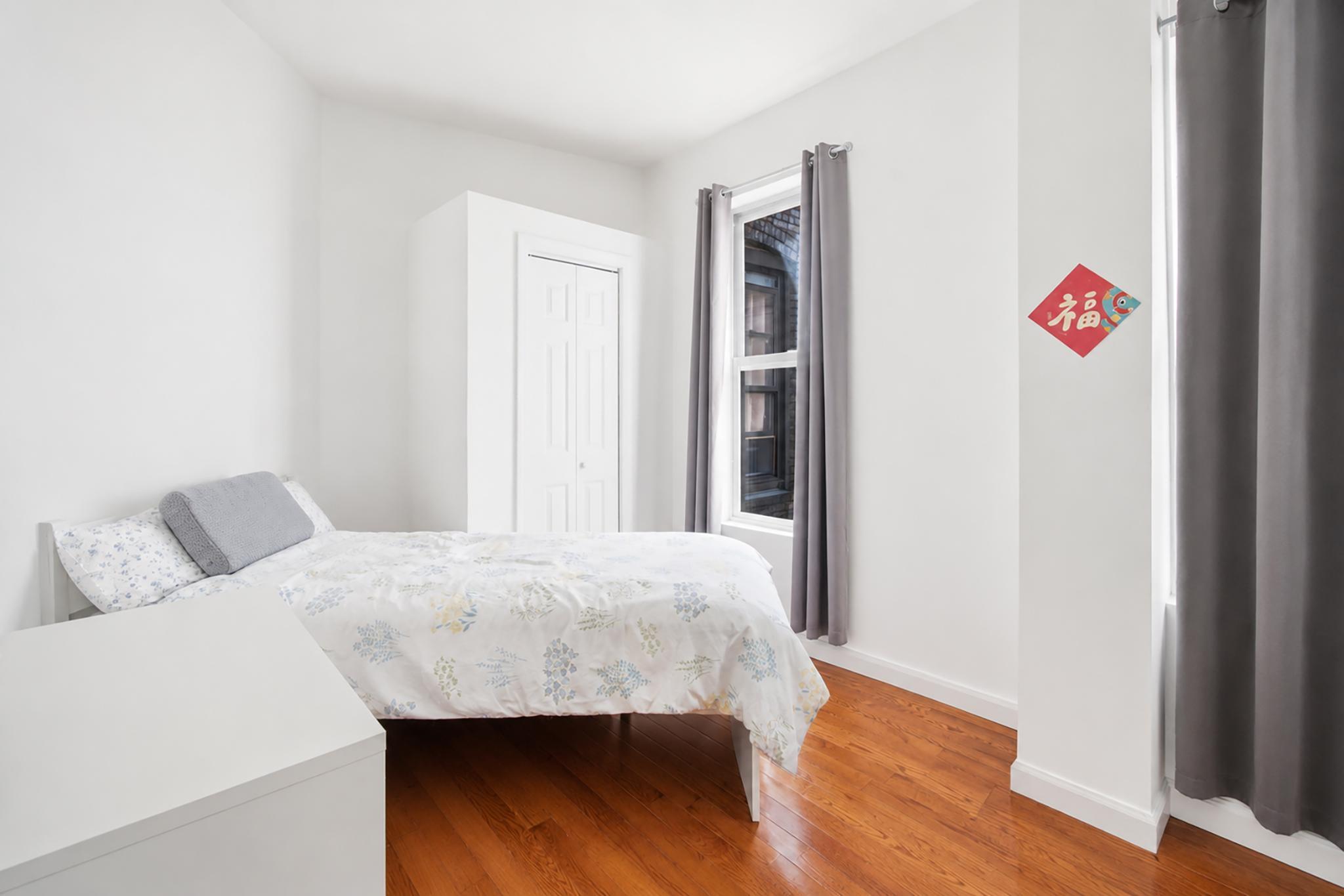 205 West 103rd Street, Unit 6B Manhattan, NY 10025 - Photo 6 of 11 a bedroom with a bed and a dresser