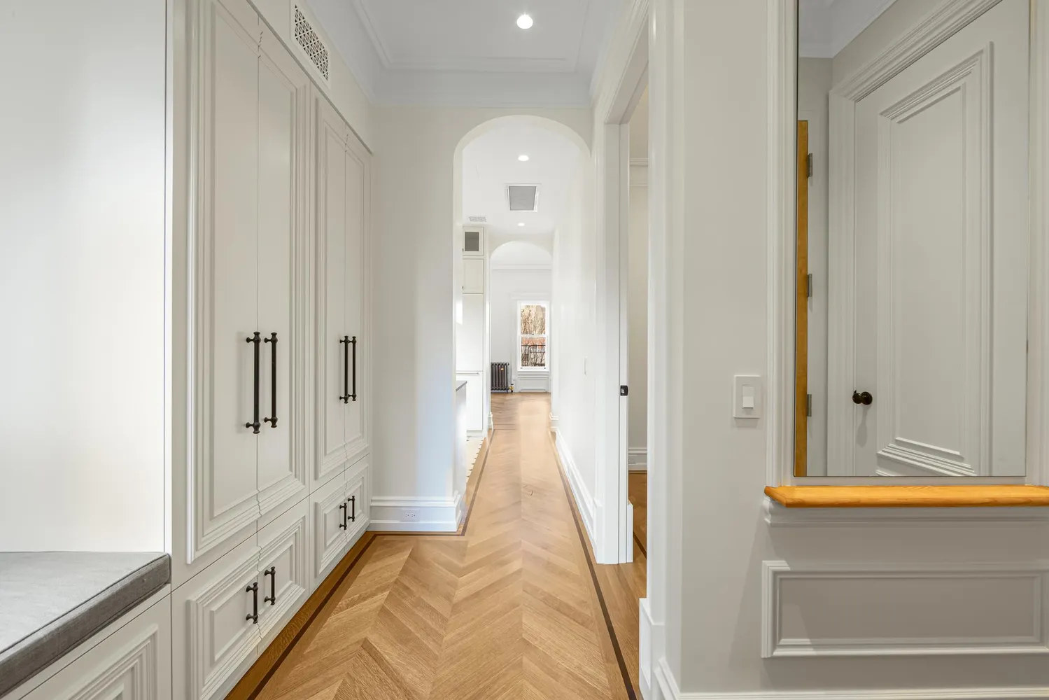 a view of a hallway with wooden floor and staircase