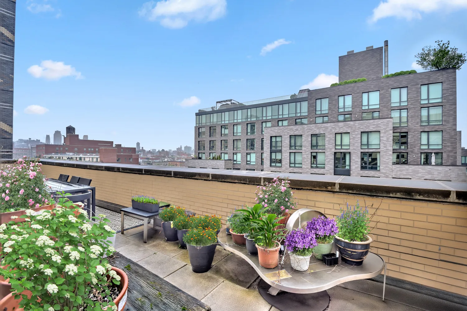 a view of a balcony with two chairs and a potted plant