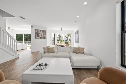 a view of a dining room with furniture wooden floor and chandelier