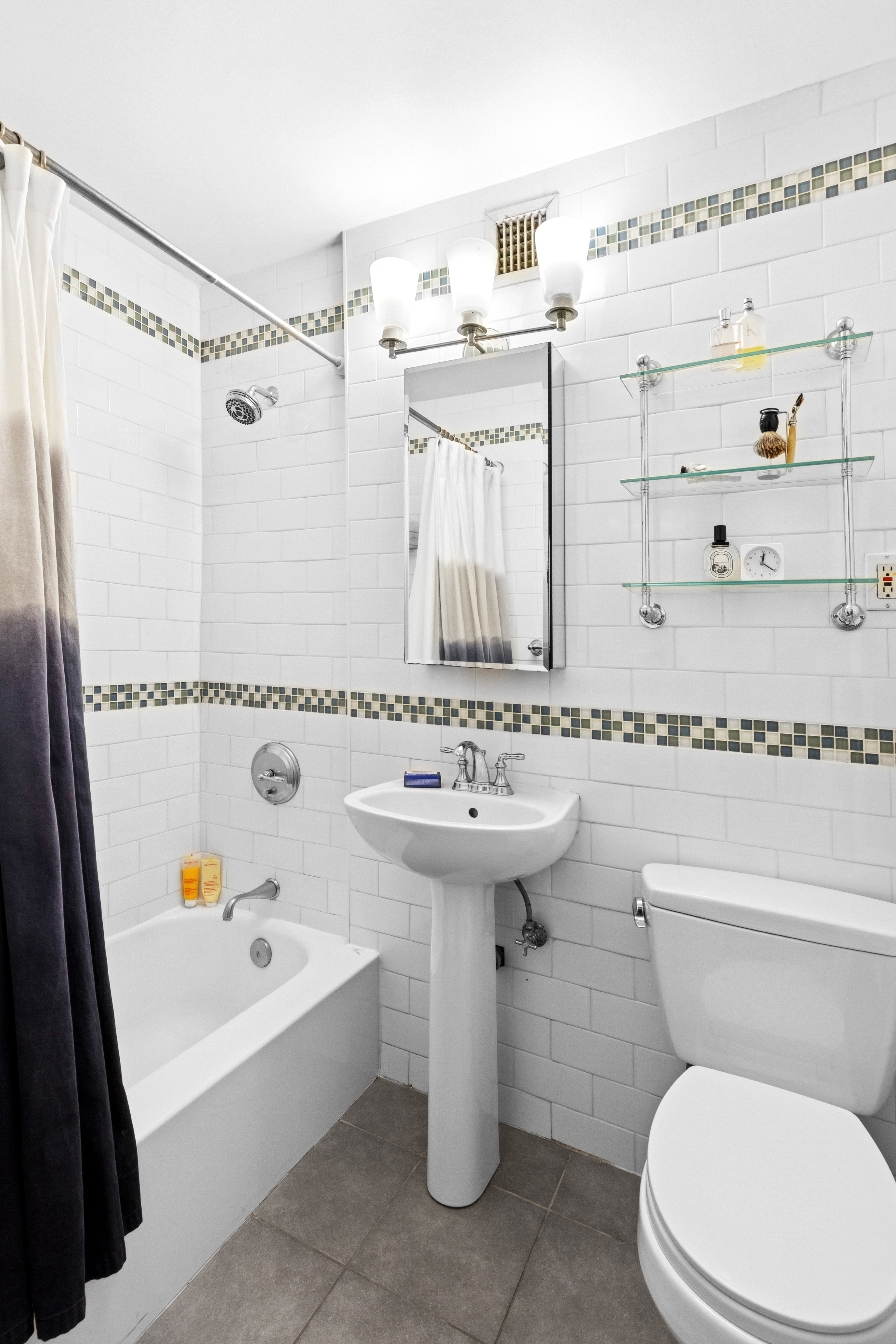 333 East 79th Street, Unit 5P Manhattan, NY 10075 - Photo 9 of 13 a bathroom with a sink toilet and shower