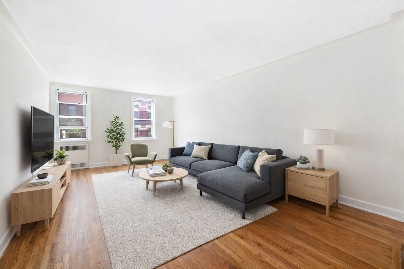 310 West 55th Street, Unit 5G Manhattan, NY 10019 - Photo 1 of 7 a living room with furniture and a flat screen tv