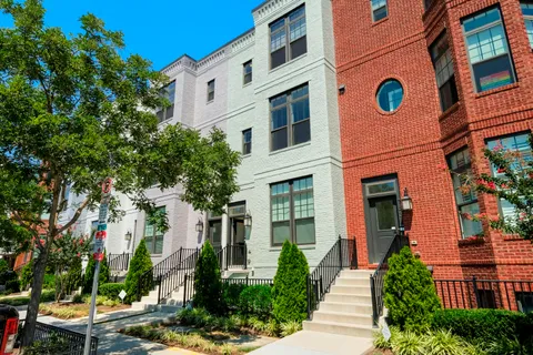 a front view of a multi story residential apartment building with a yard