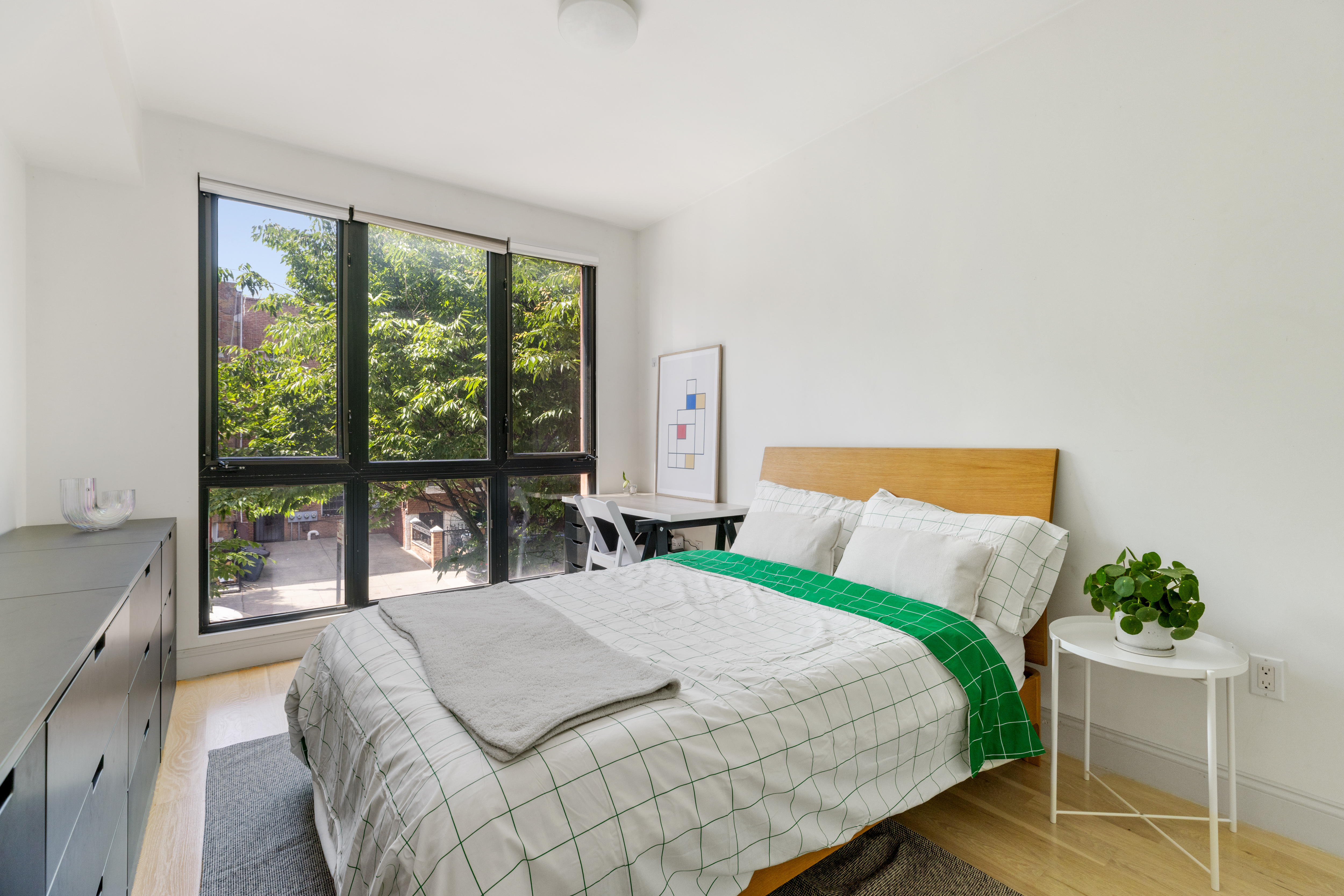 1094 Madison Street, Unit 2A Brooklyn, NY 11221 - Photo 4 of 7 a bedroom with a bed and a large window
