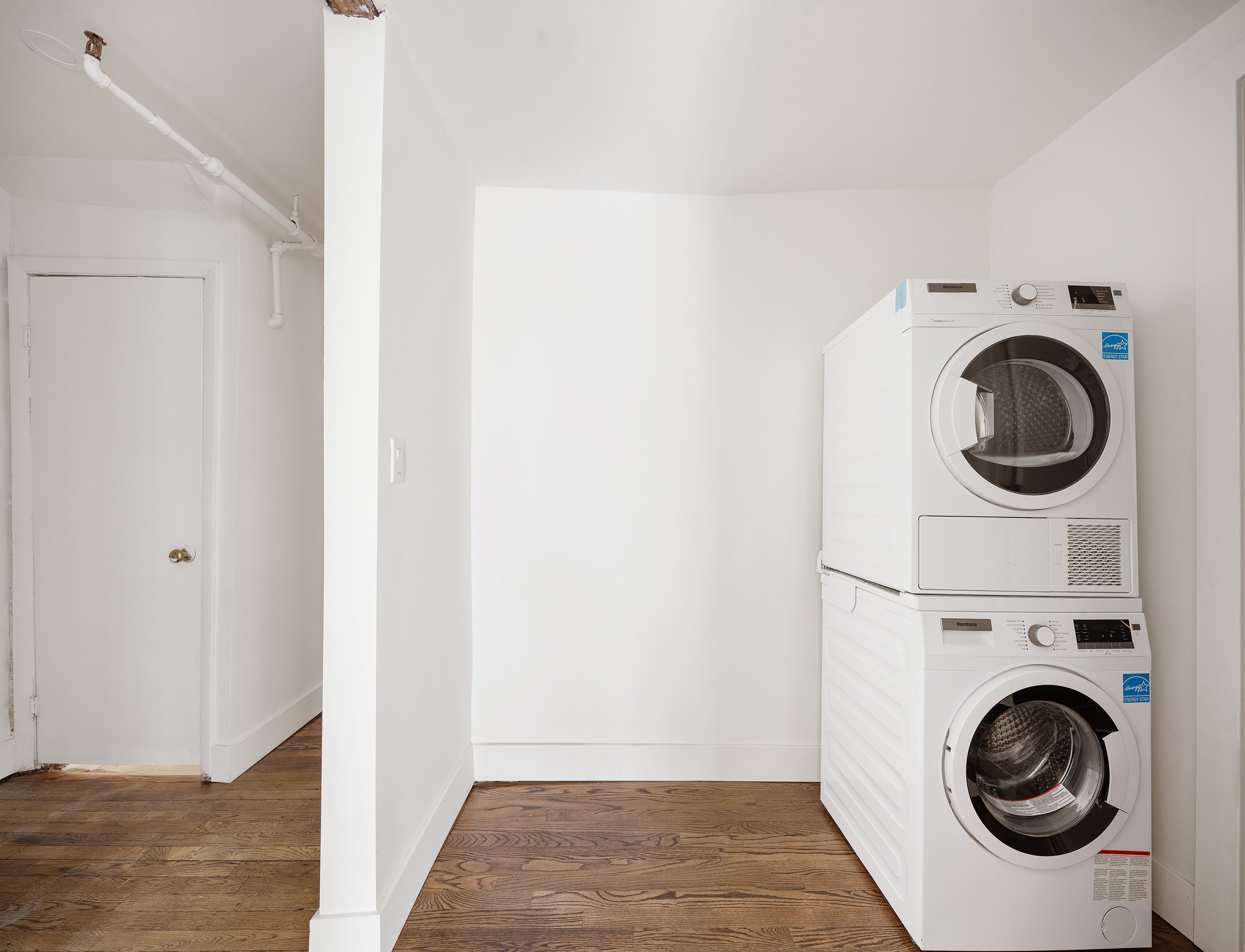 306 Gates Avenue, Unit 1A Brooklyn, NY 11216 - Photo 8 of 14 a view of a hallway with washer and dryer