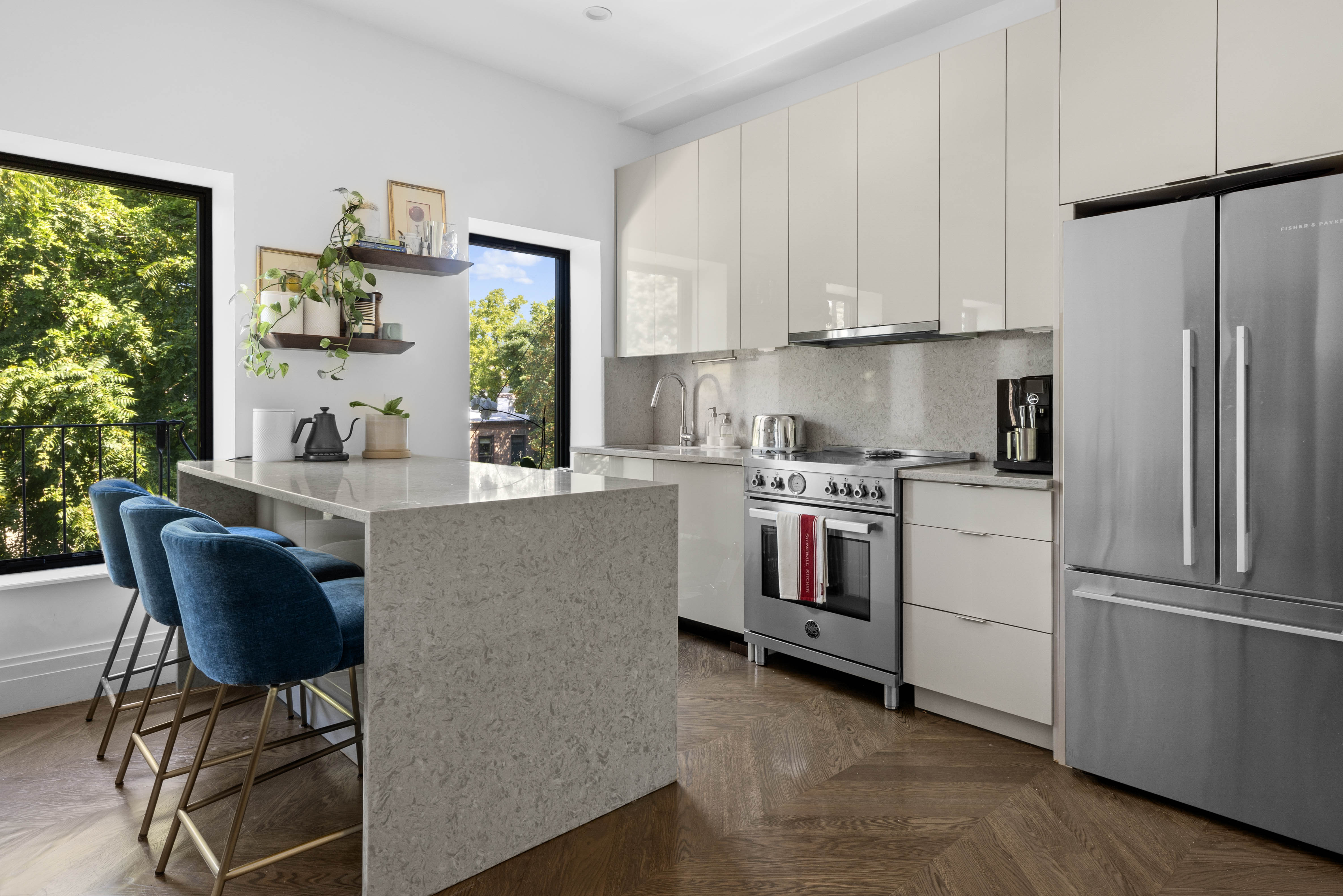 773 Greene Avenue, Unit 4 Brooklyn, NY 11221 - Photo 3 of 10 a kitchen with stainless steel appliances granite countertop a refrigerator a stove a sink dishwasher and white cabinets with wooden floor