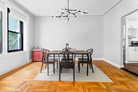 a view of a dining room with furniture and wooden floor