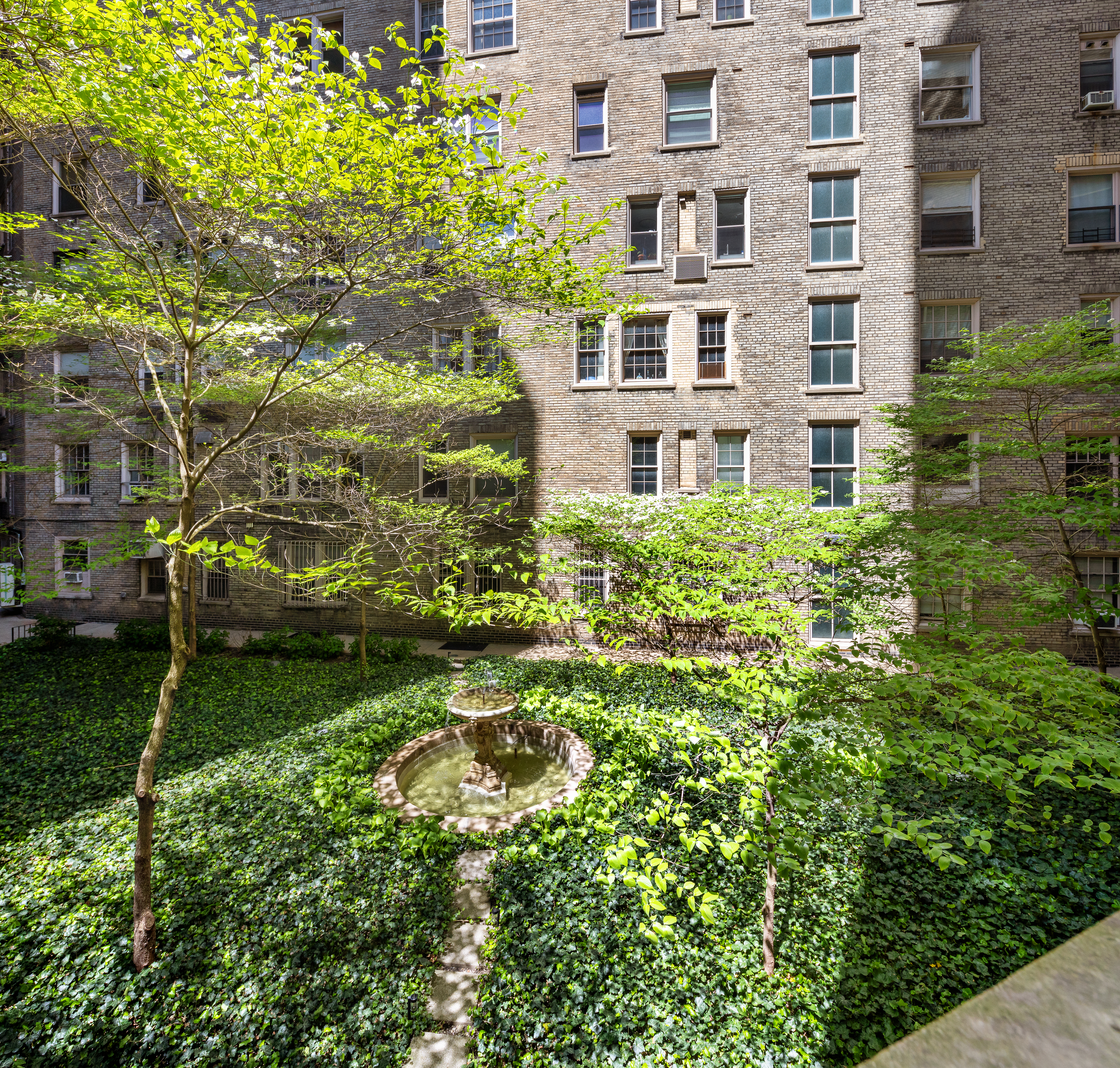 173-175 Riverside Drive, Unit 2L Manhattan, NY 10024 - Photo 6 of 18 a view of a building with a garden