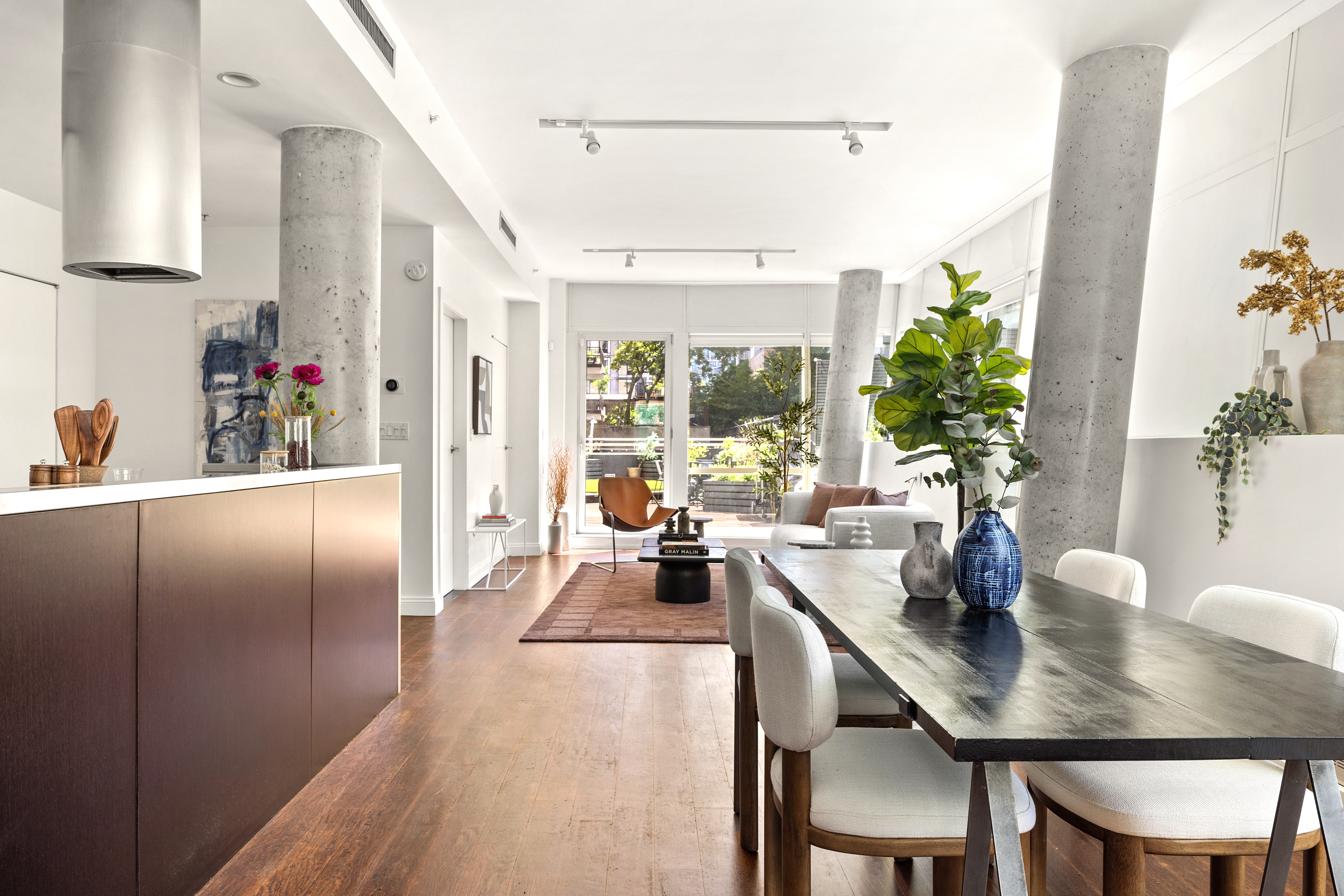 245 10th Avenue, Unit 2W Manhattan, NY 10001 - Photo 1 of 16 a dining room with furniture and a potted plant