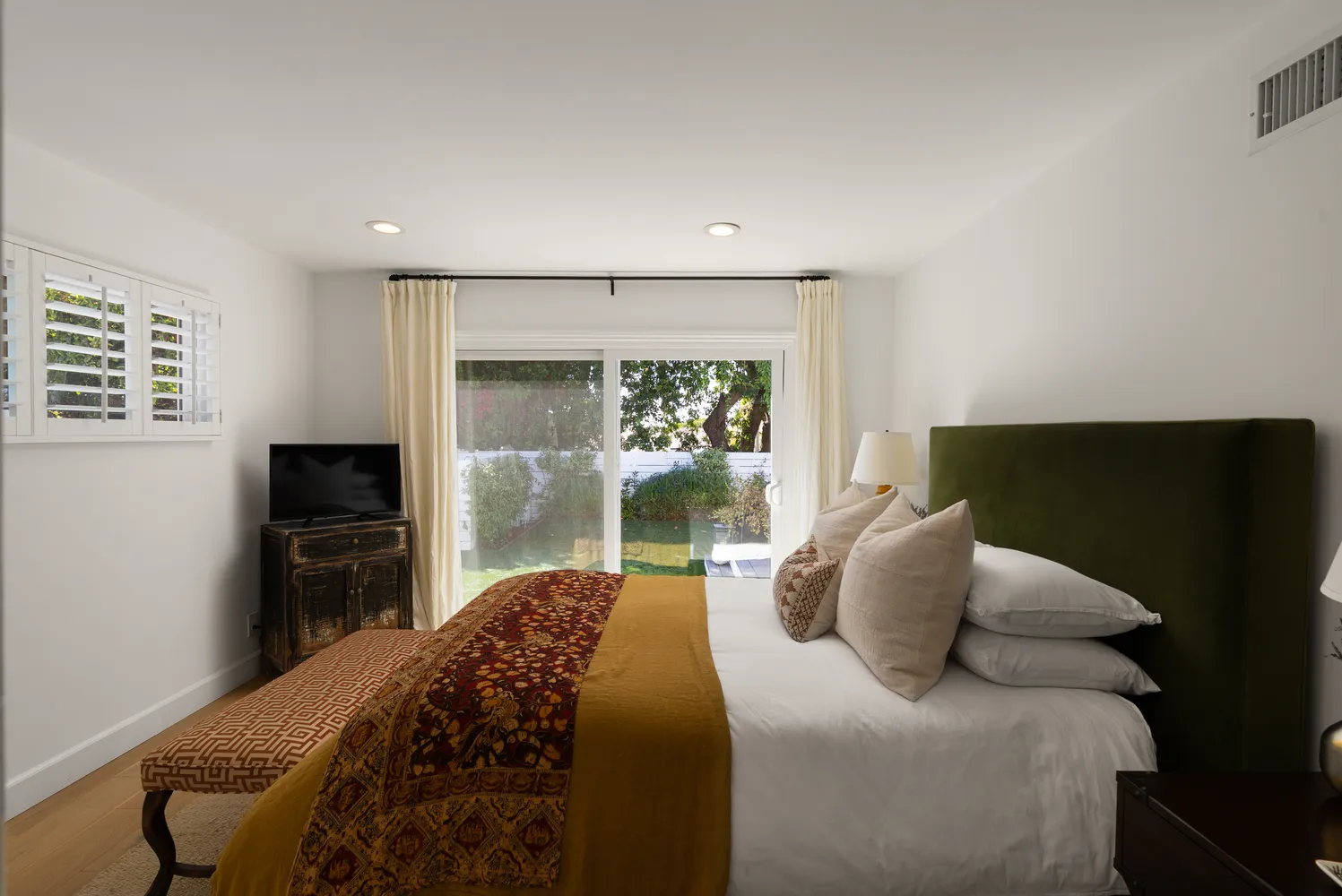 a bedroom with a bed and a large window