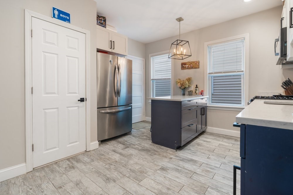 24 Buttonwood Street Boston, MA 02125 - Photo 21 of 43 a kitchen with stainless steel appliances granite countertop a refrigerator a stove a sink and a refrigerator