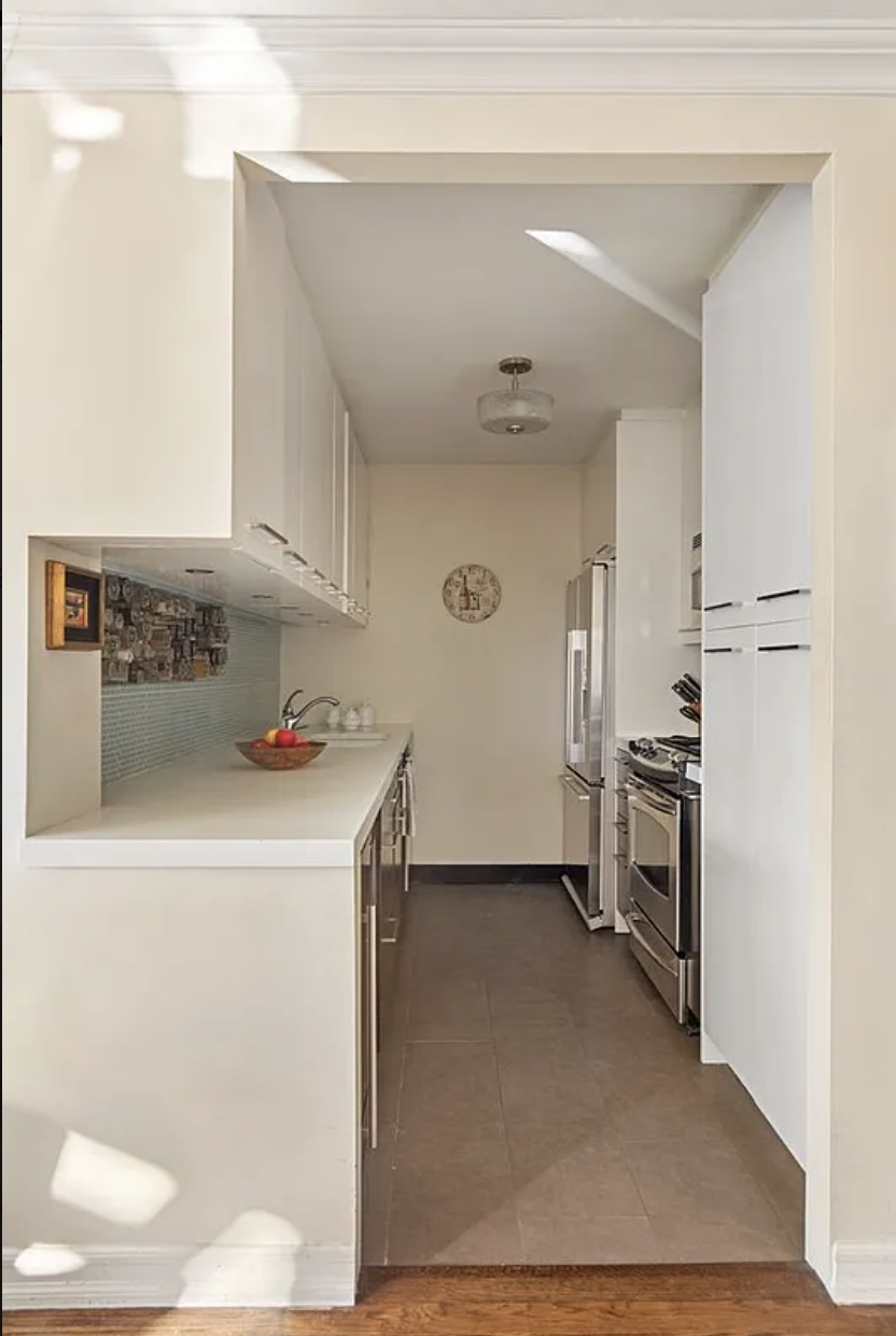 1441 3rd Avenue, Unit 14A Manhattan, NY 10028 - Photo 4 of 10 a kitchen with a sink and refrigerator