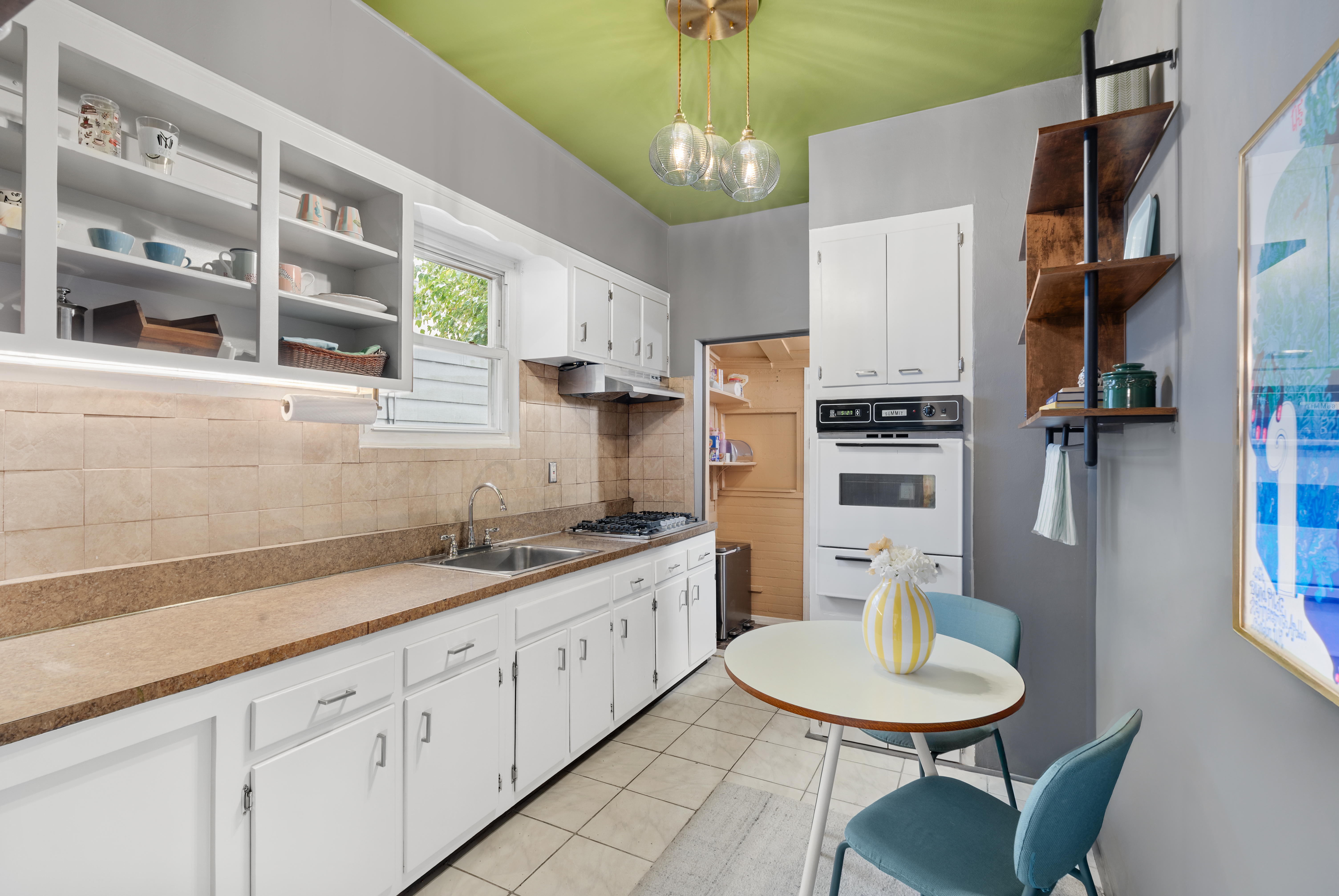138 East 29th Street Brooklyn, NY 11226 - Photo 4 of 12 a kitchen with stainless steel appliances kitchen island granite countertop a dining table chairs and a refrigerator