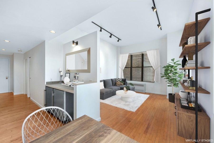 67 Hudson Street, Unit 4C Manhattan, NY 10013 - Photo 2 of 9 a living room with furniture a potted plant and open kitchen view