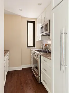 a kitchen with stainless steel appliances granite countertop a stove and a refrigerator