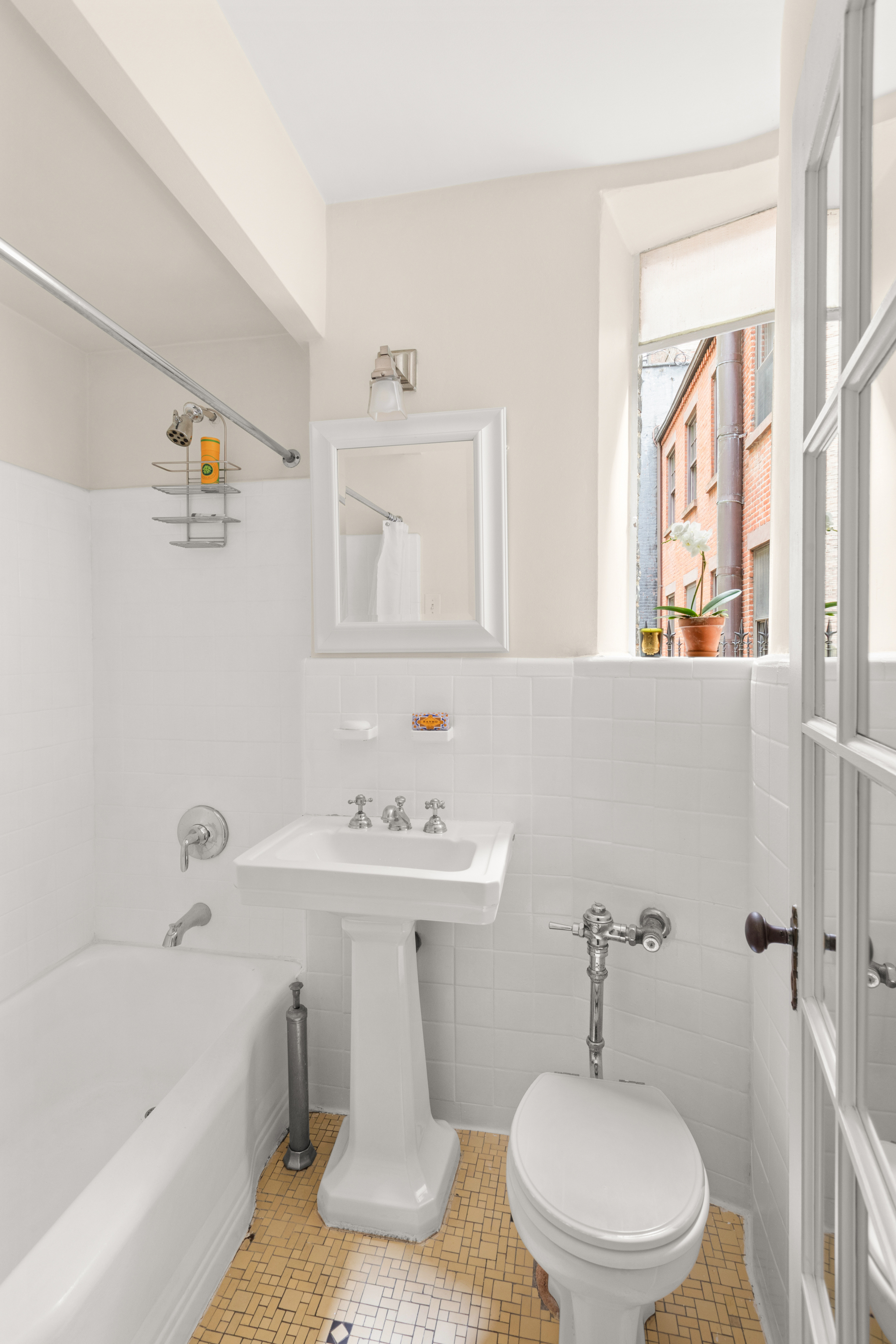 51 East 78th Street, Unit 3BC Manhattan, NY 10075 - Photo 20 of 25 a bathroom with a sink a toilet and shower