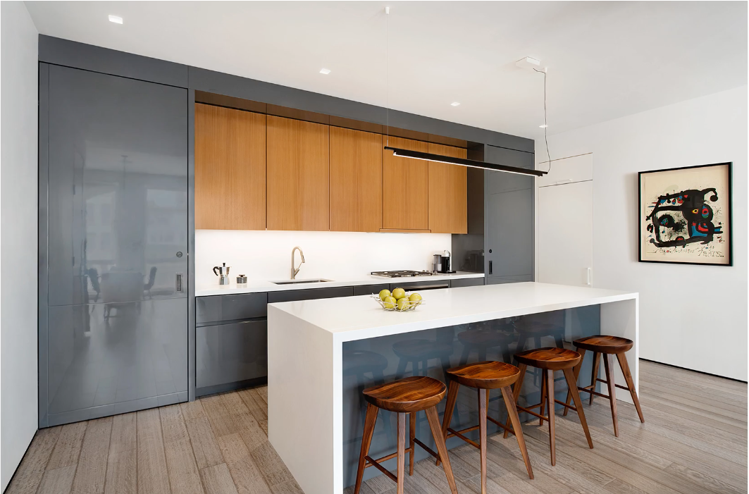 40 West 17th Street, Unit 9A Manhattan, NY 10011 - Photo 4 of 12 a kitchen with stainless steel appliances a table and chairs in it